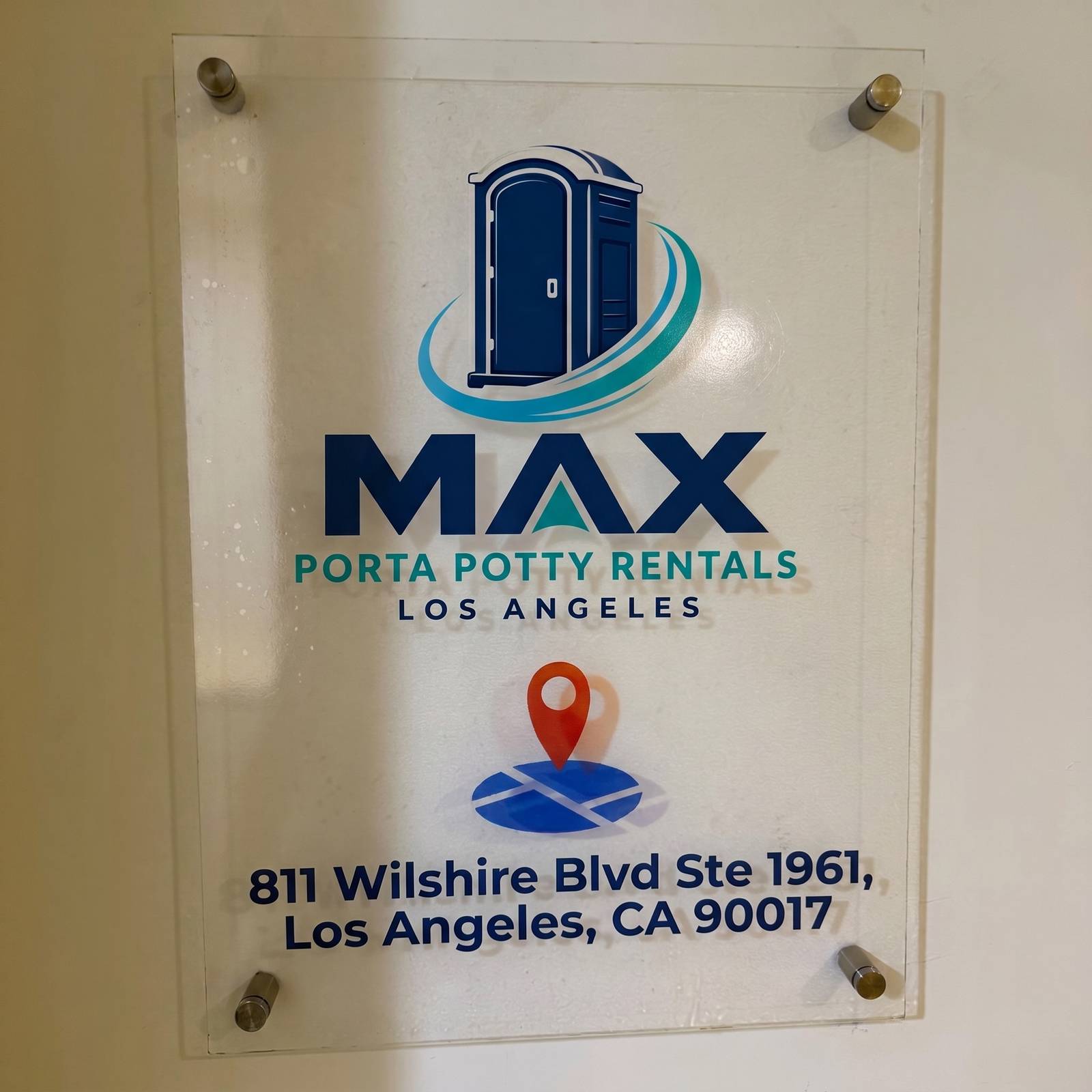 Close-up of the Max Porta Potty Rentals signage plaque