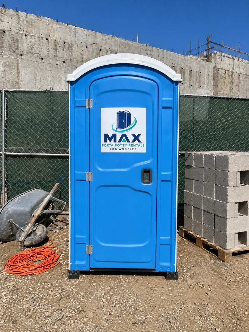 Blue porta potty on a concrete construction site